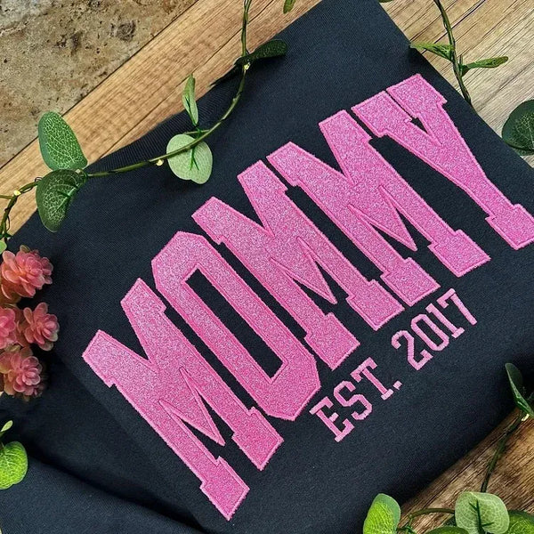 Glitzerndes Mama-Sweatshirt mit gestickter Applikation und Kindernamen auf dem Ärmel