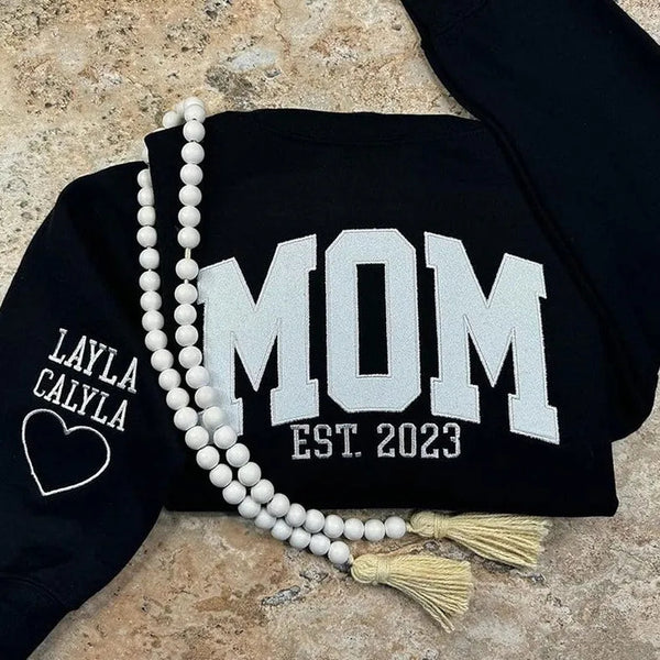 Glitzerndes Mama-Sweatshirt mit gestickter Applikation und Kindernamen auf dem Ärmel